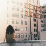 woman-in-gray-top-sitting-on-a-buildings-edge-stockpack-unsplash